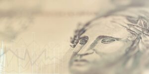 montagem com nota de real e gráfico do mercado financeiro