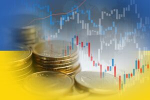 Imagem de gráficos e moedas, ilustrando o sobe e desce do mercado financeiro.