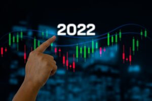 Ilustração de gráfico de ações com mão apontando para o ano de 2022