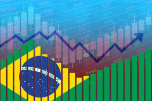 Cotações e gráficos com a bandeira do Brasil ao fundo
